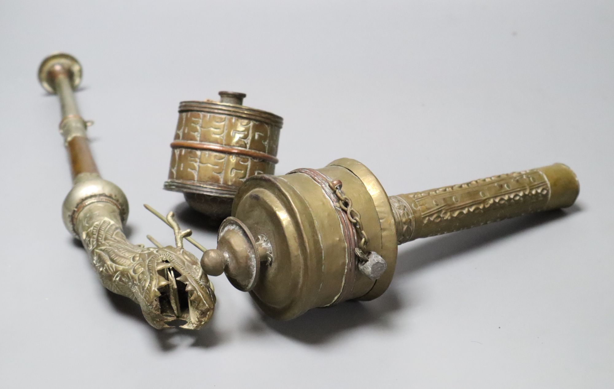 A Himalayan Buddhist brass trumpet and two prayer wheels